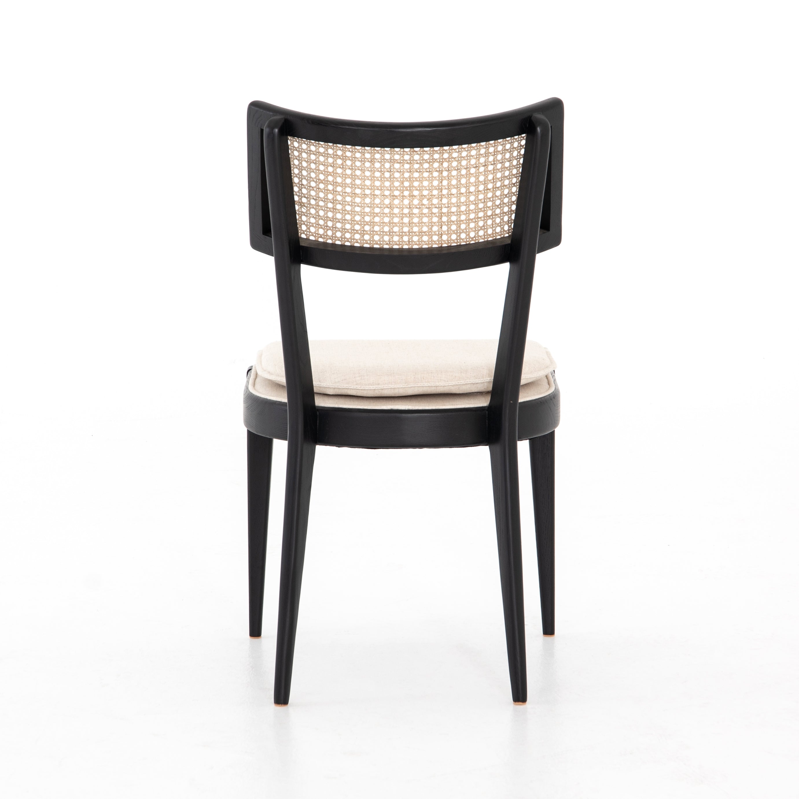 Featuring Britt Brushed Ebony Dining Chair by Four Hands at Amethyst Home. Mixed materials refresh retro dining style. Ebony-finished nettlewood frames a textural inlay of natural cane, for perfect contrast. Fastened by Velcro, high-performance linen-blend seating for modern sensibility. Performance fabrics are specially created to withstand spills, stains, high traffic and wear, ensu. Amethyst Home provides interior design, new construction, custom furniture and area rugs in the Dallas metro area