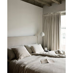 Featuring Revive Removable Linen Sand Bed by Ethnicraft at Amethyst Home. Find solace in the Revive bed, where comfort meets practicality. Its linen headboard, effortlessly removable for dry cleaning, ensures a fresh and inviting space. Stitched details add a touch of refined elegance and create a soft backdrop that whispers tranquility into the bedroo.  Amethyst Home provides interior design, new home construction design consulting, vintage area rugs, and lighting in the Winter Garden metro area.