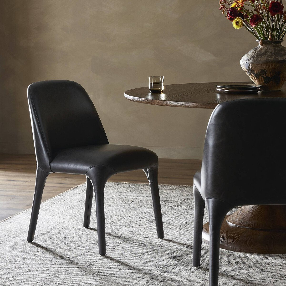 Featuring Bensen Sonoma Black Dining Chair by Four Hands at Amethyst Home. Experience the ultimate dining comfort with the Bensen Sonoma Black Dining Chair. Designed for both style and comfort, this chair features a sleek black design that will elevate any dining space. With its sturdy construction and ergonomic design, you can enjoy every meal in pure re. Amethyst Home provides interior design, new home construction design consulting, vintage area rugs, and lighting in the Kansas City metro area.