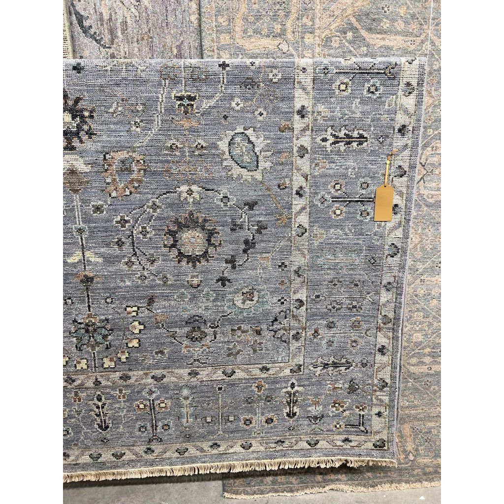 Featuring Rhapsody Nysa Hand-Knotted Rug by Jaipur Living at Amethyst Home. The Rhapsody collection features heirloom-quality designs of stunningly abrashed Old World patterns. The Nysa area rug boasts a beautifully washed floral motif with a decorative border. The blue tone is accented with rich green, tan, navy, and cream hues for added depth and intrigu.  Amethyst Home provides interior design, new home construction design consulting, vintage area rugs, and lighting in the Park City metro area.