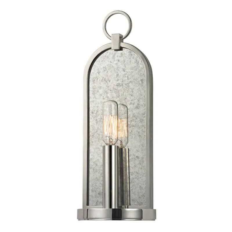 A clean, classic arch, fitted with a cast ring at the apex, provides a handsome frame for the mottled haze of Lowell’s smokey mirror backplate. The clean lines of its metal candlestick provide contemporary contrast to its antique inspiration, while a tungsten filament bulb reflects with quiet drama. Amethyst Home provides interior design, new home construction design consulting, vintage area rugs, and lighting in the Houston metro area.