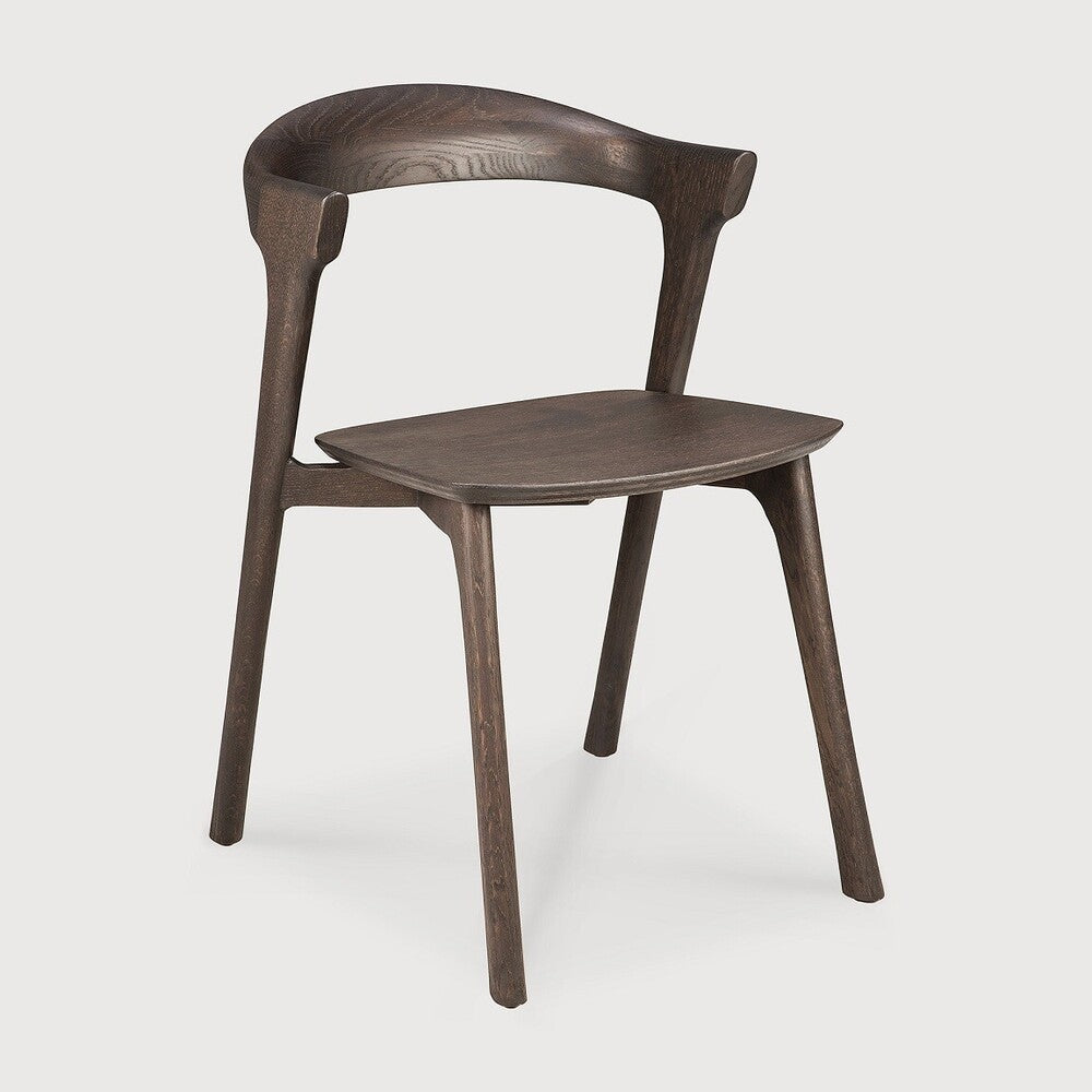 Over the years, the Bok dining chair has become one of our most recognisable designs. Designer Alain van Havre combines sculptural elegance and contemporary crafting into a graceful and airy form.
Seating height: 46cm - 18".
Made from brown tainted oak with a varnish finish. Amethyst Home provides interior design, new construction, custom furniture, and area rugs in the Houston metro area