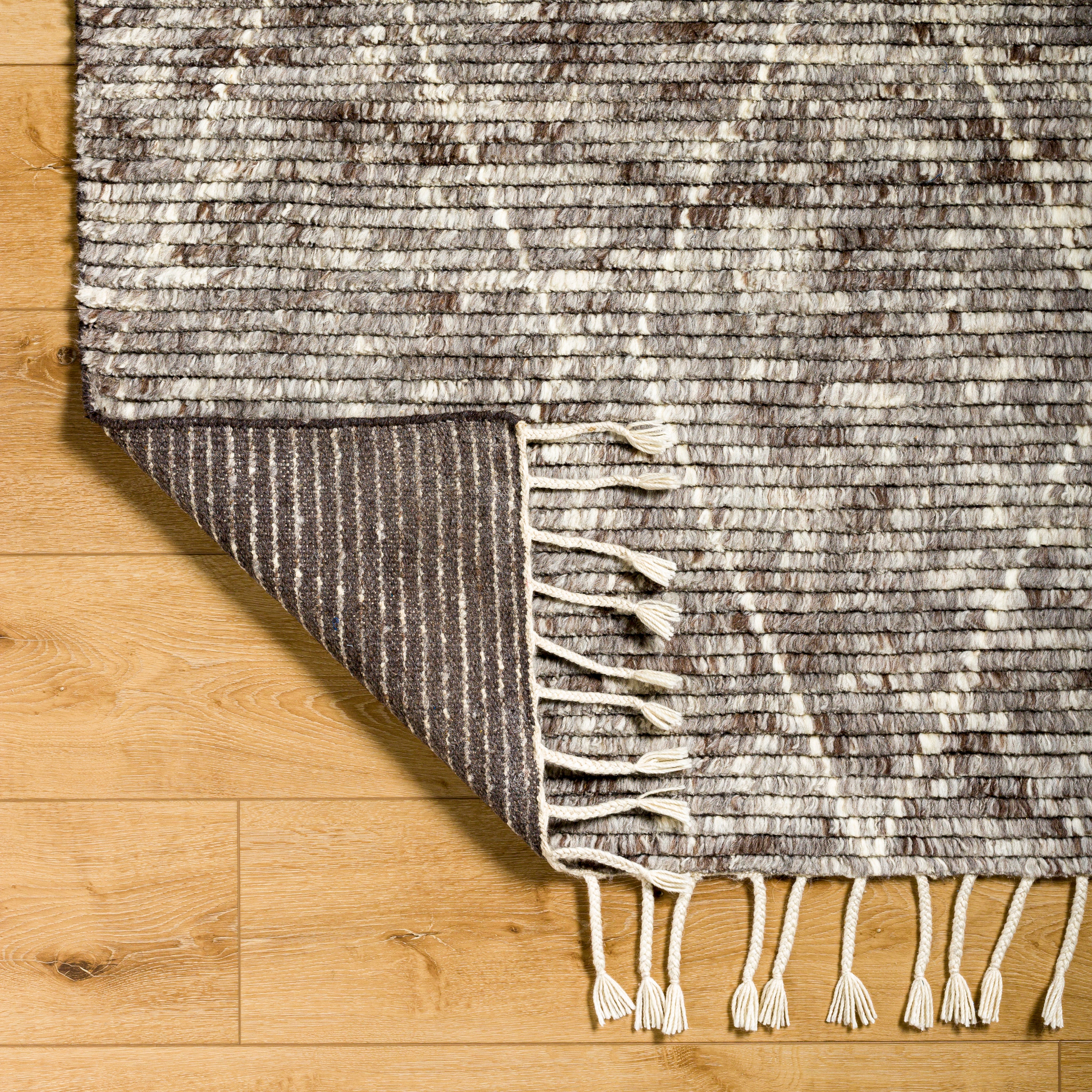 Featuring Camille Jasper Wolf Hand-Knotted Rug by Surya at Amethyst Home. The Camille Jasper Wolf hand-knotted rug features a yummy blend of charcoal greys and chocolate brown.  Soft to the touch and made of dreamy, knotted wool in a low shed blend.
Hand-Knotted100% WoolFringe Length: 5"Rug Thickness: 0.75". Amethyst Home provides interior design, new home construction design consulting, vintage area rugs, and lighting in the Seattle metro area.