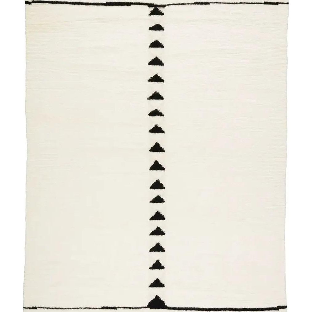 Featuring Desouk Vendace Rug by Jaipur Living at Amethyst Home. The Desouk collection melds modern allure with the global vibes of Morocco. The Vendace hand-knotted rug showcases a geometric linear pattern with contrasting black and cream tones. This handcrafted rug boasts plush, cut wool pile that pairs beautifully with braided tassel details. Perfect for adding warmth to cozy bedrooms and sit. Amethyst Home provides interior design services, furniture, rugs, and lighting in the Omaha metro area.