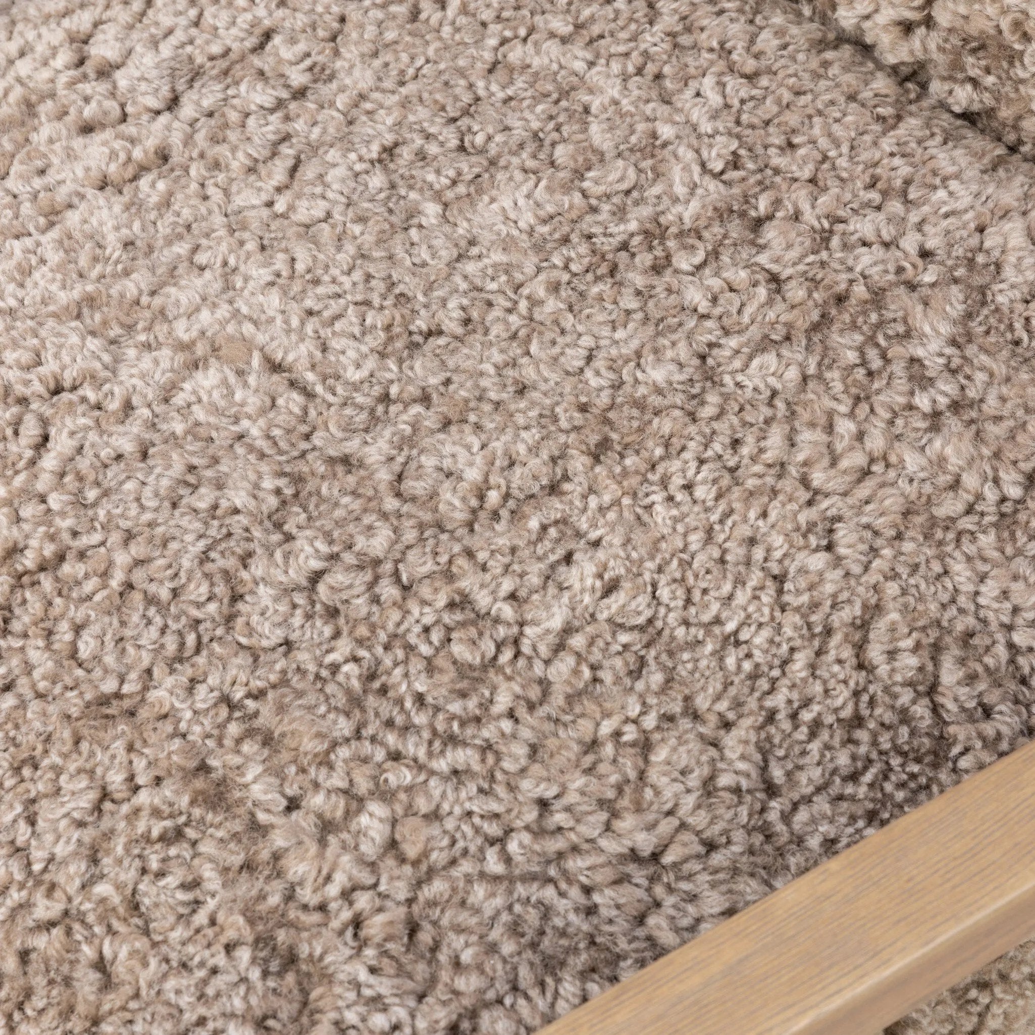 The perfect place to curl up with a good book. A hand-shaped parawood frame supports low, deep seating upholstered with taupe shearling Amethyst Home provides interior design, new home construction design consulting, vintage area rugs, and lighting in the Alpharetta metro area.