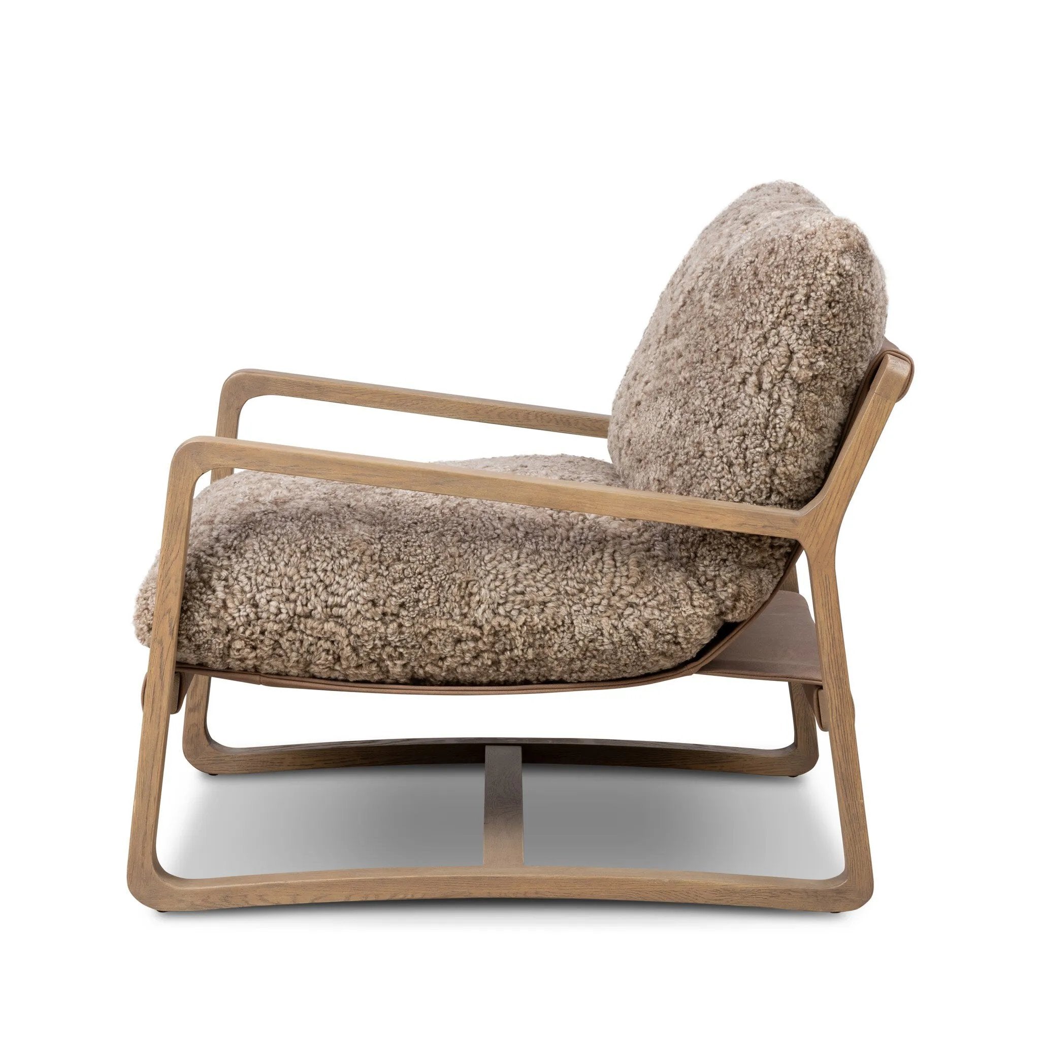 The perfect place to curl up with a good book. A hand-shaped parawood frame supports low, deep seating upholstered with taupe shearling Amethyst Home provides interior design, new home construction design consulting, vintage area rugs, and lighting in the Scottsdale metro area.