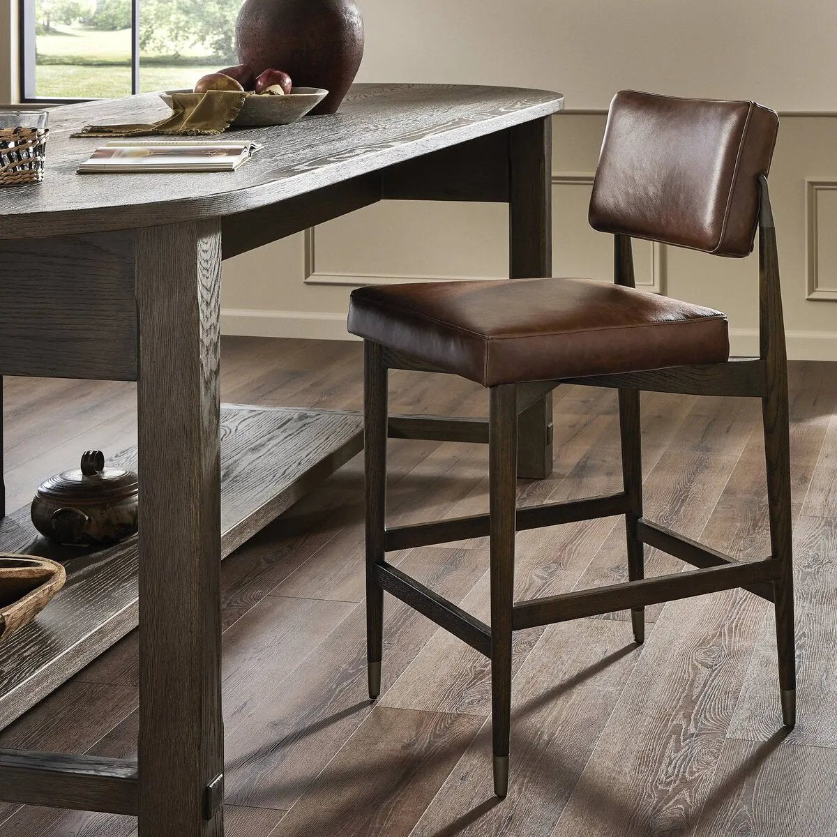 Featuring Anton Havana Brown Counter Stool by Four Hands at Amethyst Home. Crafted with a sleek Havana Brown finish, the Anton Bar + Counter Stool adds a touch of elegance to any space. The sturdy construction and ergonomic design provide exceptional support, making it suitable for extended use. Perfect for both bar and counter heights, this versatile stool. Amethyst Home provides interior design, new home construction design consulting, vintage area rugs, and lighting in the Charlotte metro area.