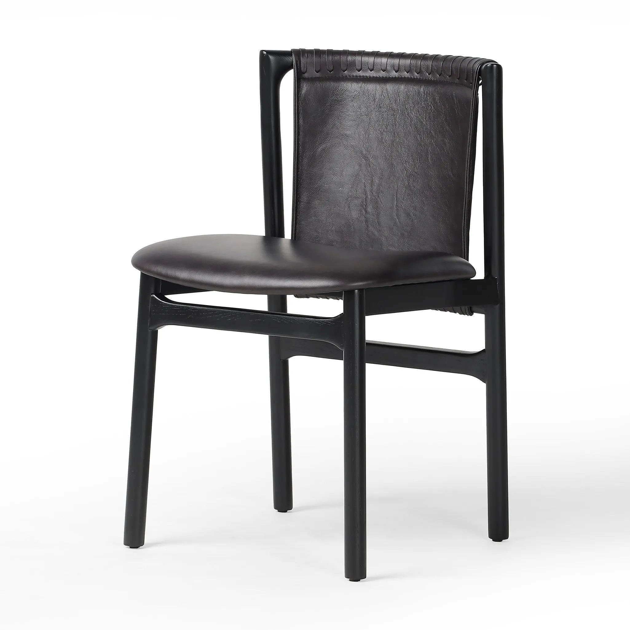 Featuring Baden Sonoma Black Dining Chair by Four Hands at Amethyst Home. Midcentury-inspired with its minimalist wooden frame, this armless dining chair features a low back and float-like seat upholstered in slightly distressed black top-grain leather exclusive to Four Hands. Leather wrap detailing for texture.Overall Dimensions: 19.75"w x 23.25"d x 32.25". Amethyst Home provides interior design, new home construction design consulting, vintage area rugs, and lighting in the Calabasas metro area.
