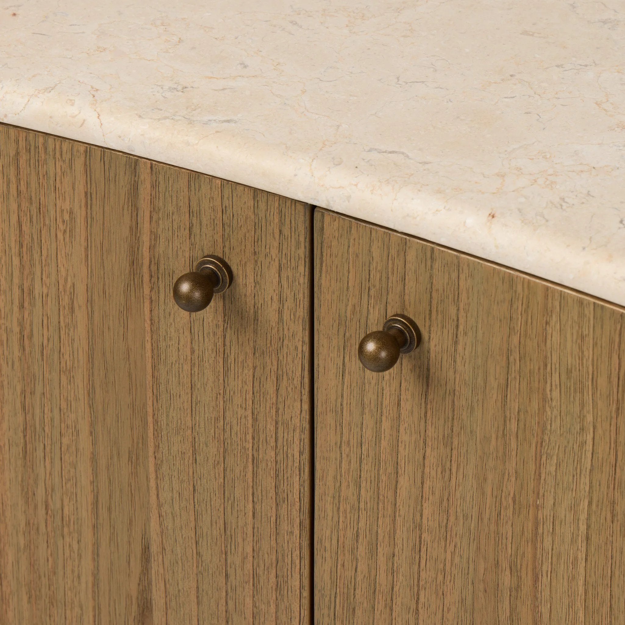 Fluid contours give shape to this solid mindi cabinet, topped with a creamy marbled top. Two doors with knobbed pulls open to inset shelves for organized storage Amethyst Home provides interior design, new home construction design consulting, vintage area rugs, and lighting in the Calabasas metro area.