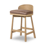 Featuring Cloris Palermo Cigar Swivel Bar + Counter Stool by Four Hands at Amethyst Home. Channel vintage vibes with a swivel stool perfectly sized for the bar. Crafted of blonde-finished oak, a low, molded back adds a playful touch, while a top-grain leather seat offers luxe comfort. Finished off with a memory swivel to ensure the stool's curved wood ba. Amethyst Home provides interior design, new home construction design consulting, vintage area rugs, and lighting in the Laguna Beach metro area.