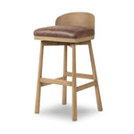 Featuring Cloris Palermo Cigar Swivel Bar + Counter Stool by Four Hands at Amethyst Home. Channel vintage vibes with a swivel stool perfectly sized for the bar. Crafted of blonde-finished oak, a low, molded back adds a playful touch, while a top-grain leather seat offers luxe comfort. Finished off with a memory swivel to ensure the stool's curved wood back stay. Amethyst Home provides interior design, new home construction design consulting, vintage area rugs, and lighting in the Omaha metro area.