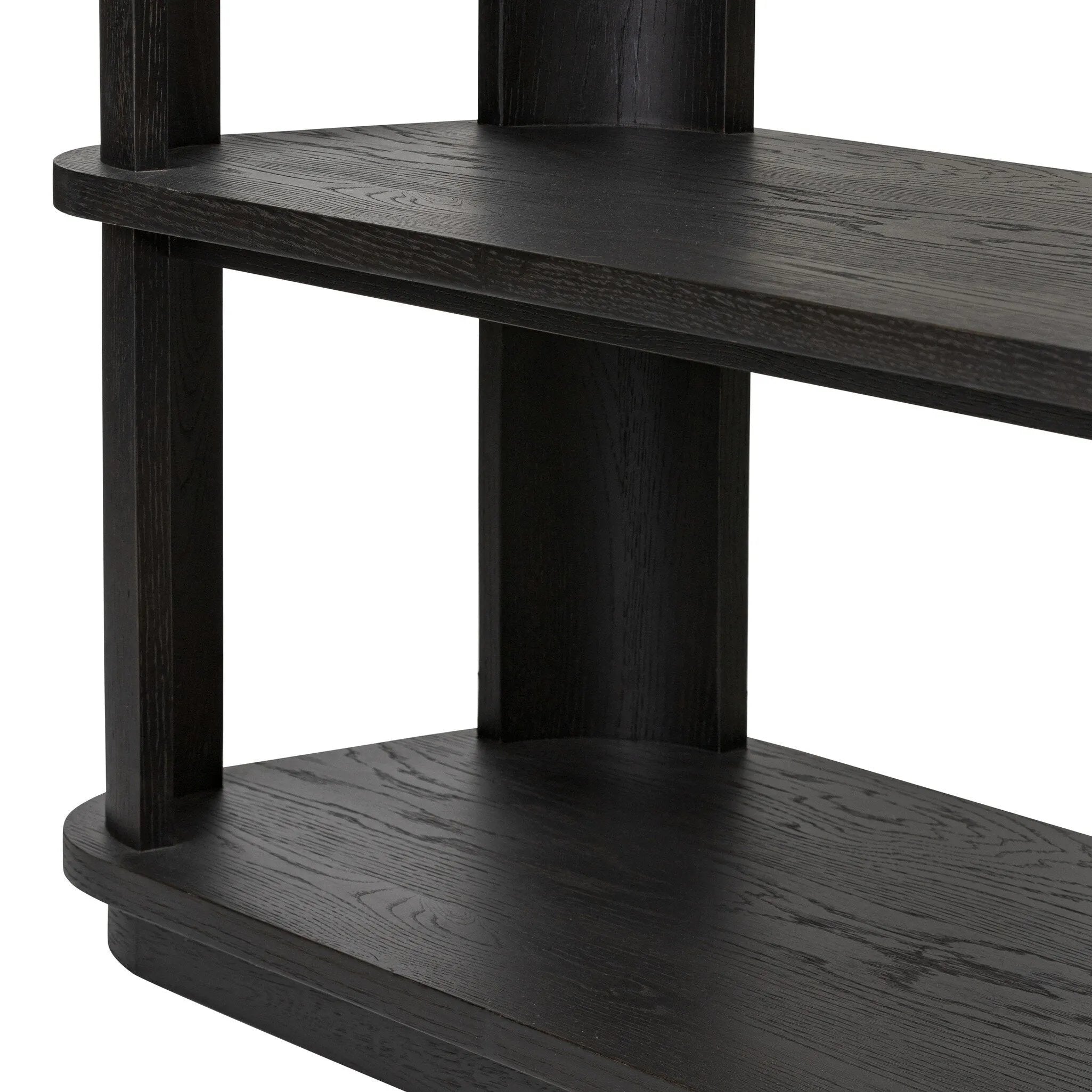Unexpected contours give this bookcase its warm, modern vibe. Crafted oak veneer with a worn black finish, rounded legs are inset from the shelves with a plinth-like effect Amethyst Home provides interior design, new home construction design consulting, vintage area rugs, and lighting in the Omaha metro area.