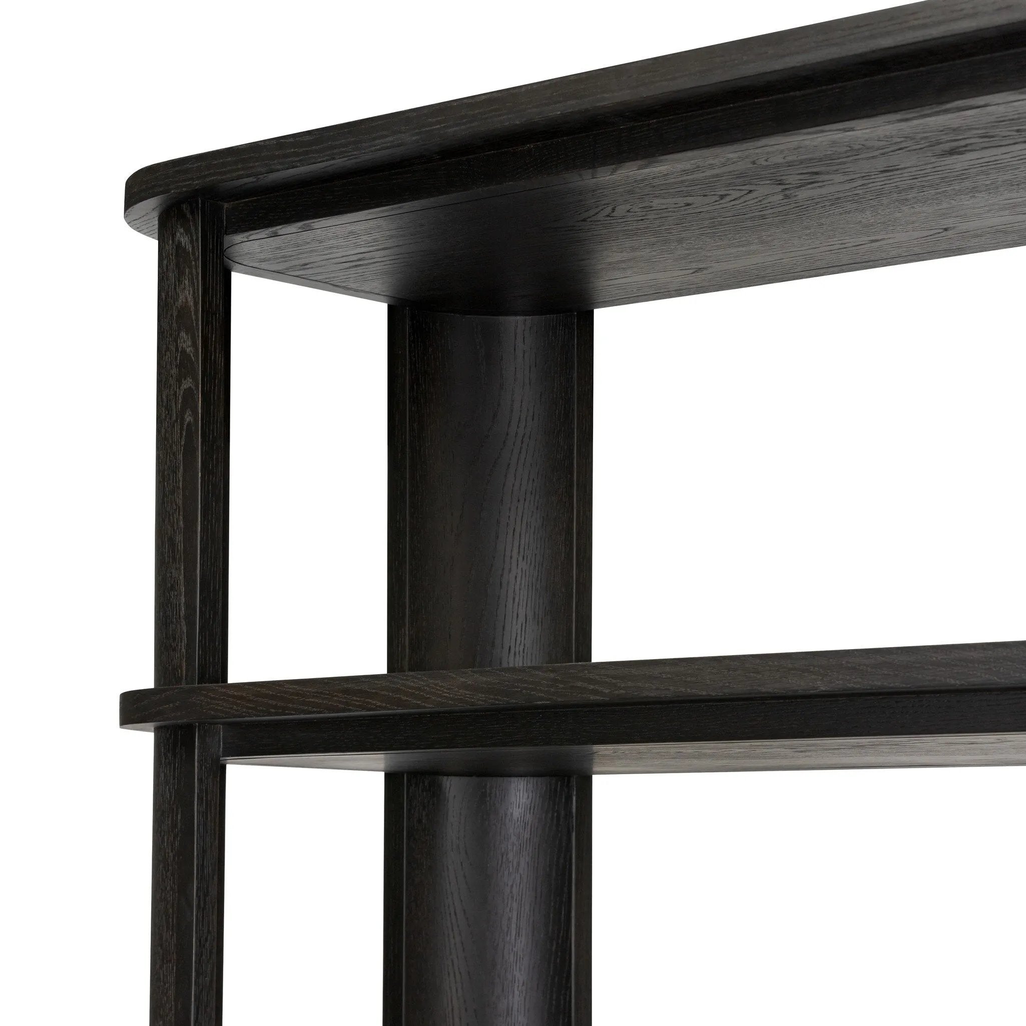 Unexpected contours give this bookcase its warm, modern vibe. Crafted oak veneer with a worn black finish, rounded legs are inset from the shelves with a plinth-like effect Amethyst Home provides interior design, new home construction design consulting, vintage area rugs, and lighting in the Winter Garden metro area.