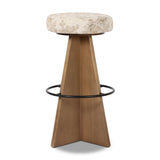 Large angular panels merge to form a geometrically inspired base in this modern counter stool. The circle metal ring around the base serves as a footrest, while the round upholstered cushion provides comfortable seating. The 360-degree swivel function adds versatility, and the combination of wood, metal, and fabric evoke a mixed material moment Amethyst Home provides interior design, new home construction design consulting, vintage area rugs, and lighting in the Omaha metro area.