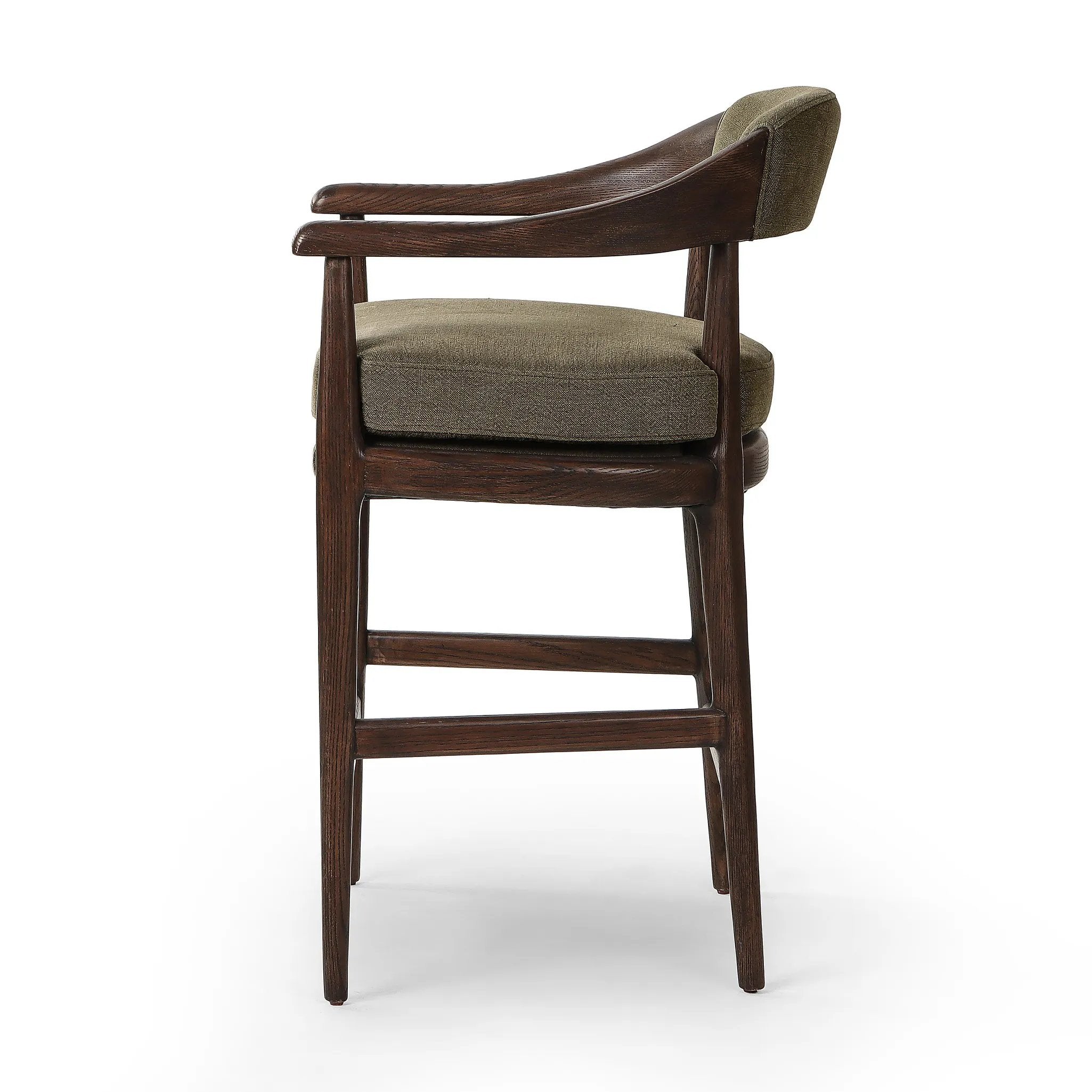Featuring Dane Broadway Olive Stool by Four Hands at Amethyst Home. Traditional safari styling is brought to modern speed. A solid wood frame features a webbed seating structure that brings a supported, sink-in feel to the entire piece. The upholstered back, strap details and loose cushion are finished in an olive flax/linen-blend fabric. Perfectly size. Amethyst Home provides interior design, new home construction design consulting, vintage area rugs, and lighting in the Winter Garden metro area.