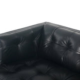 A modernized midcentury silhouette meets the traditional Chesterfield sofa, all in a compact profile perfect for smaller spaces. Top-grain leather in a classic black, button tufting and a smooth touch bring deep comfort to lounging Amethyst Home provides interior design, new home construction design consulting, vintage area rugs, and lighting in the Charlotte metro area.