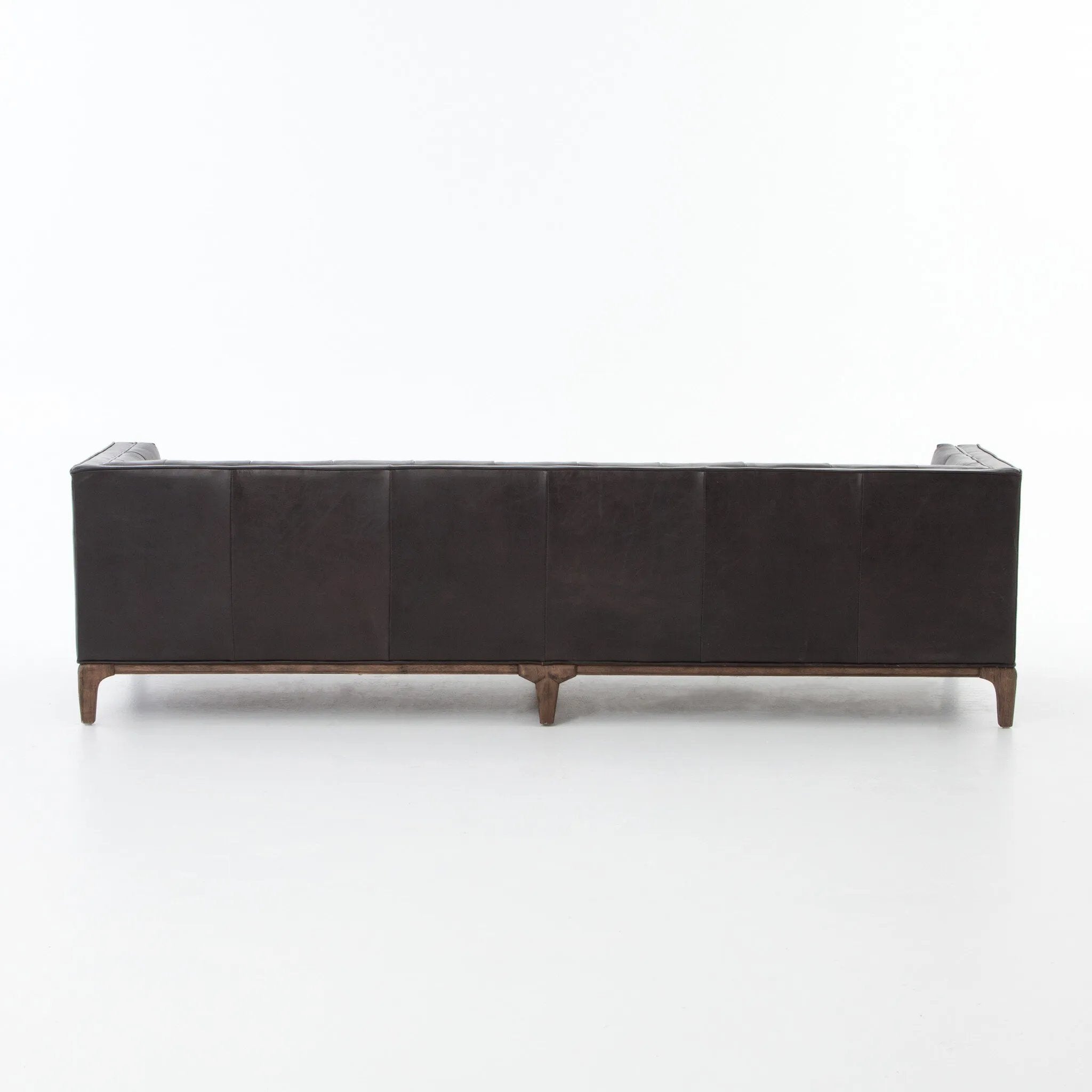 A modernized midcentury silhouette meets the traditional Chesterfield sofa, all in a compact profile perfect for smaller spaces. Top-grain leather in a classic black, button tufting and a smooth touch bring deep comfort to lounging Amethyst Home provides interior design, new home construction design consulting, vintage area rugs, and lighting in the Omaha metro area.