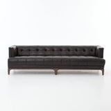 A modernized midcentury silhouette meets the traditional Chesterfield sofa, all in a compact profile perfect for smaller spaces. Top-grain leather in a classic black, button tufting and a smooth touch bring deep comfort to lounging Amethyst Home provides interior design, new home construction design consulting, vintage area rugs, and lighting in the San Diego metro area.
