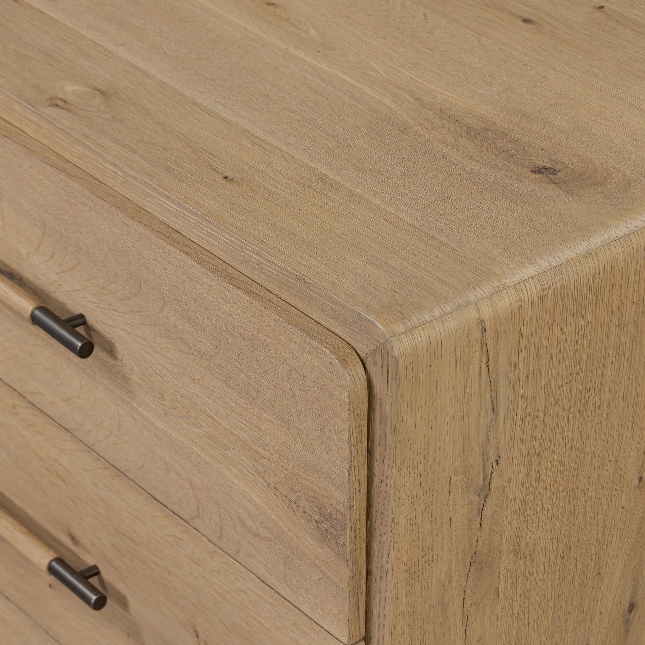Simple and spacious, this oak dresser has six drawers paired with aged bronze and wood hardware. Waterfall shaping and soft-close undermount glides give a smooth finish Amethyst Home provides interior design, new home construction design consulting, vintage area rugs, and lighting in the Newport Beach metro area.
