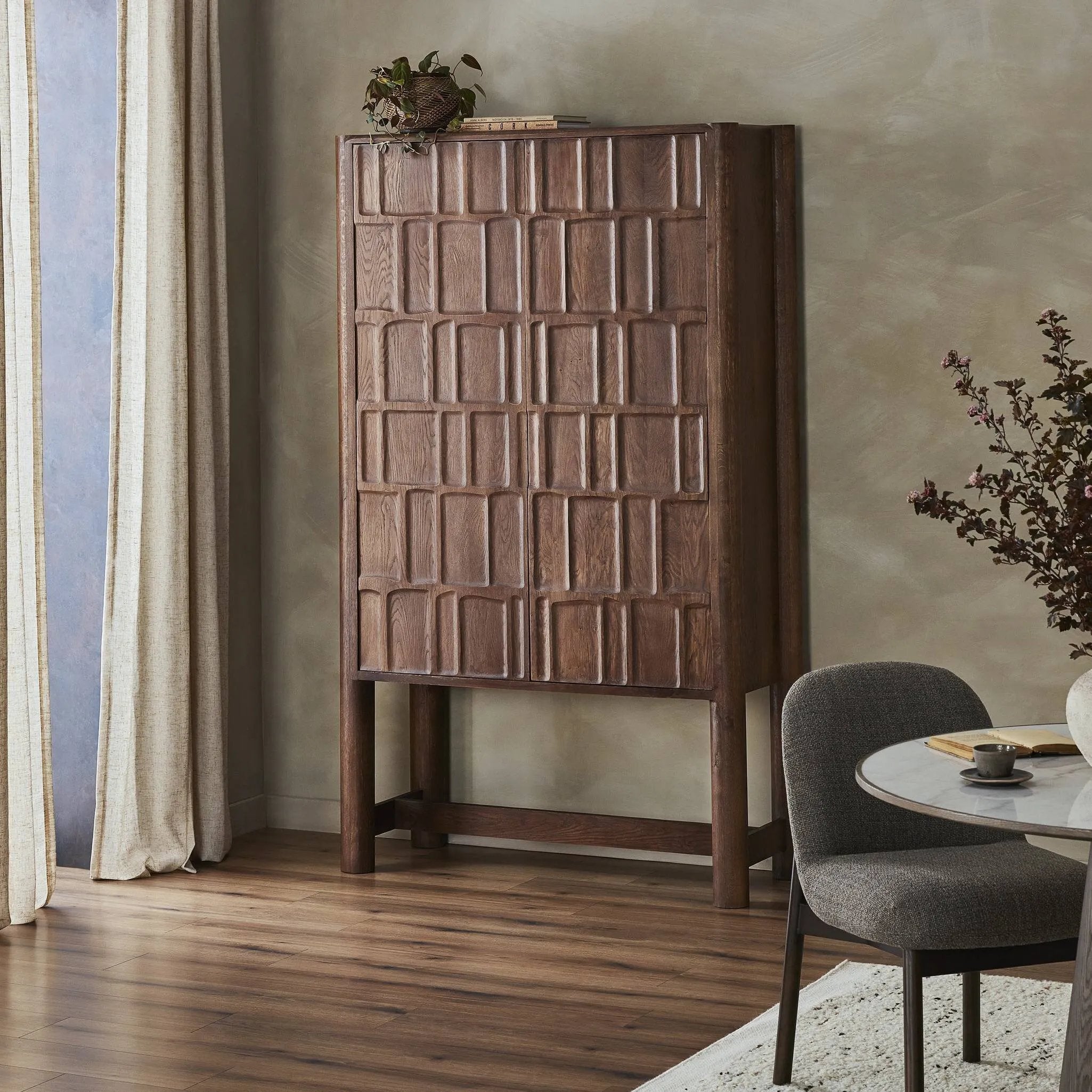 Featuring Ezri Cocoa Oak Cabinet by Four Hands at Amethyst Home. Made from solid oak and finished in a rich cocoa, tall cabinetry is carved with a unique grid-like pattern, for an organic look and textural touch. Interior shelving made from solid mango brings bonus storage to any room. Subtle variations in natural wood graining to be expected.Overall Dimen. Amethyst Home provides interior design, new home construction design consulting, vintage area rugs, and lighting in the Des Moines metro area.