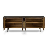 Featuring Fletcher Terra Brown Oak Media Console by Four Hands at Amethyst Home. Rich with reeding for texture and a linear look, this brown oak media console features four doors with brushed brass hardware and curved corners. Its top is a slab of bluestone, adding a striking material mix, while white mineral lines and natural variations mark the unique. Amethyst Home provides interior design, new home construction design consulting, vintage area rugs, and lighting in the Newport Beach metro area.