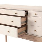 A soft statement console table with ample storage, inspired by a dresser silhouette. The elevated case is wrapped in painted linen and sits atop an oak base for a light and airy look Amethyst Home provides interior design, new home construction design consulting, vintage area rugs, and lighting in the Laguna Beach metro area.