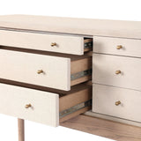 A soft statement console table with ample storage, inspired by a dresser silhouette. The elevated case is wrapped in painted linen and sits atop an oak base for a light and airy look Amethyst Home provides interior design, new home construction design consulting, vintage area rugs, and lighting in the Laguna Beach metro area.