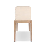 A soft statement console table with ample storage, inspired by a dresser silhouette. The elevated case is wrapped in painted linen and sits atop an oak base for a light and airy look Amethyst Home provides interior design, new home construction design consulting, vintage area rugs, and lighting in the Los Angeles metro area.