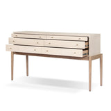 A soft statement console table with ample storage, inspired by a dresser silhouette. The elevated case is wrapped in painted linen and sits atop an oak base for a light and airy look Amethyst Home provides interior design, new home construction design consulting, vintage area rugs, and lighting in the Park City metro area.