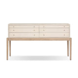 A soft statement console table with ample storage, inspired by a dresser silhouette. The elevated case is wrapped in painted linen and sits atop an oak base for a light and airy look Amethyst Home provides interior design, new home construction design consulting, vintage area rugs, and lighting in the Seattle metro area.