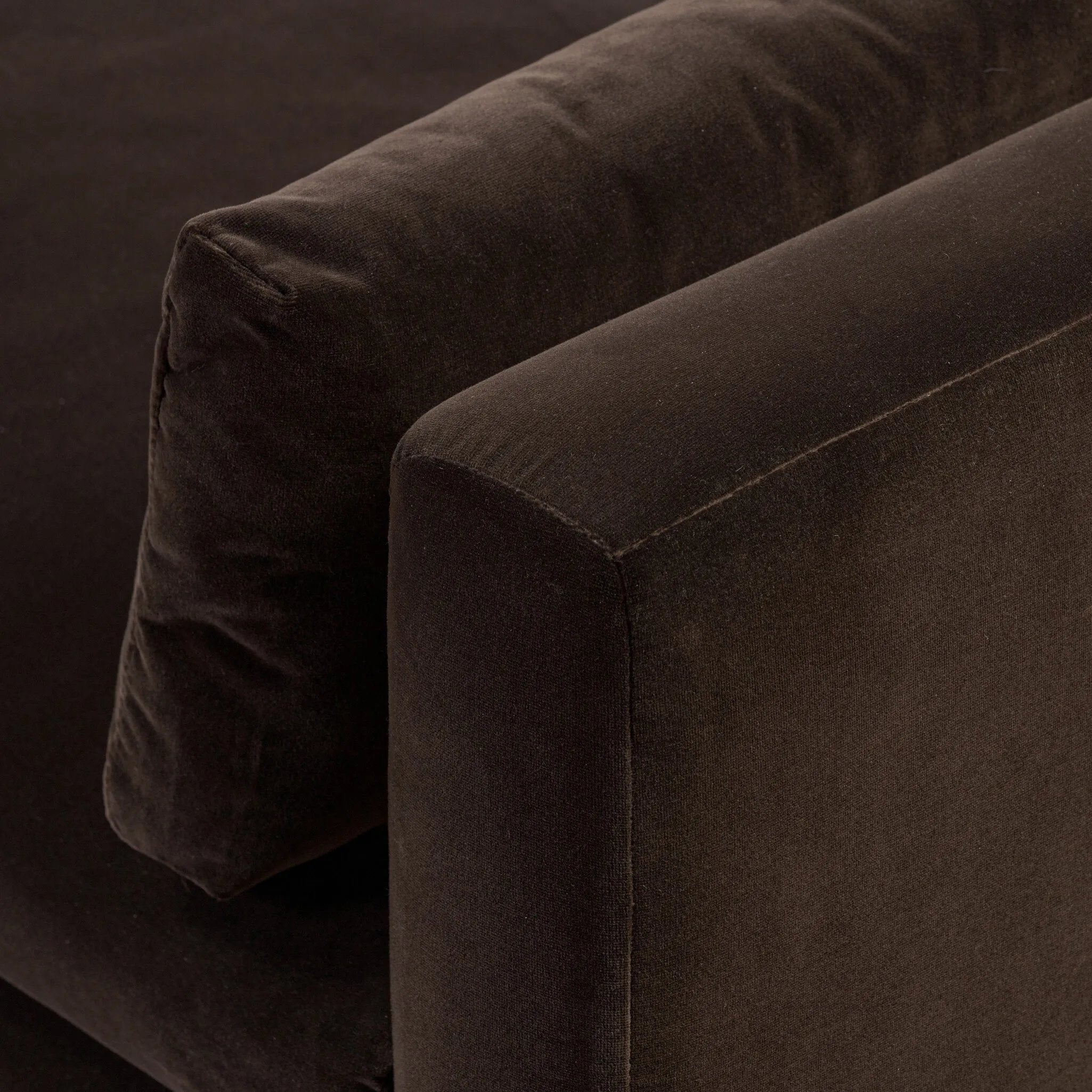 Mid-century modern with a dash of vintage detail, this bench-style sofa makes a statement. With traditional details like turned oak legs and brass casters, this low-profile sofa features an elongated bench seat for an inviting sit. Velvety chocolate-brown upholstery finishes a knife-edge back and boxed arm cushions Amethyst Home provides interior design, new home construction design consulting, vintage area rugs, and lighting in the Boston metro area.