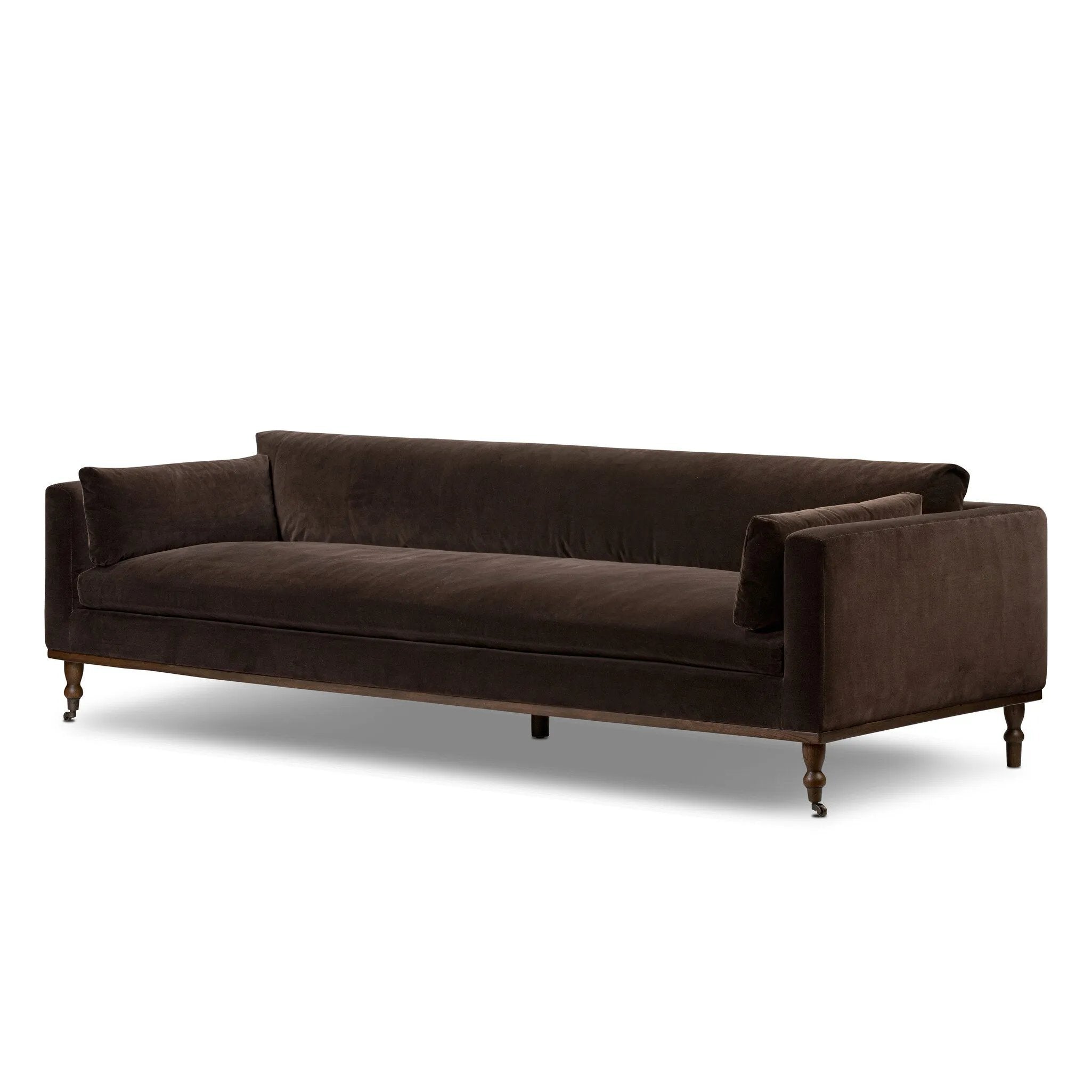 Mid-century modern with a dash of vintage detail, this bench-style sofa makes a statement. With traditional details like turned oak legs and brass casters, this low-profile sofa features an elongated bench seat for an inviting sit. Velvety chocolate-brown upholstery finishes a knife-edge back and boxed arm cushions Amethyst Home provides interior design, new home construction design consulting, vintage area rugs, and lighting in the Laguna Beach metro area.