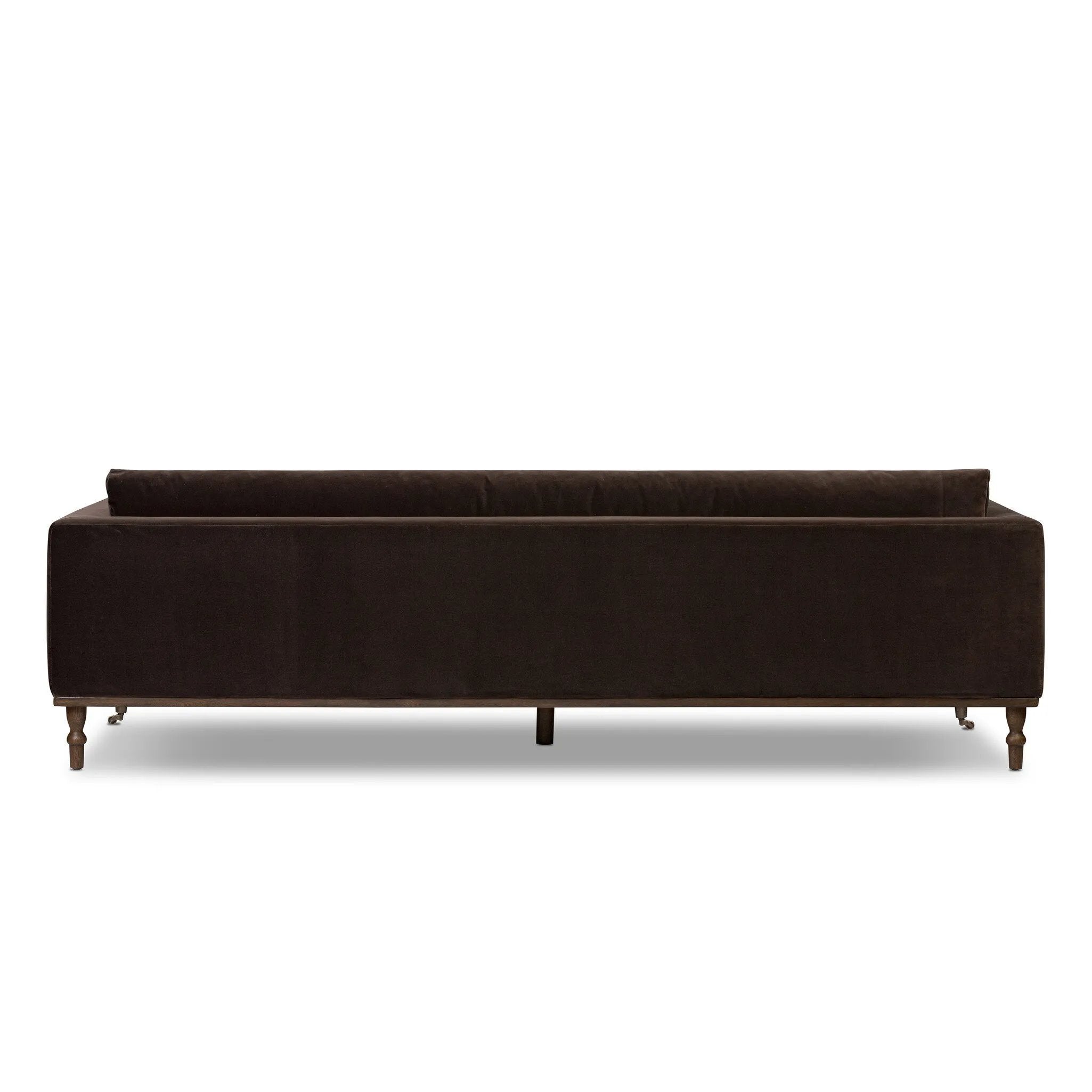 Mid-century modern with a dash of vintage detail, this bench-style sofa makes a statement. With traditional details like turned oak legs and brass casters, this low-profile sofa features an elongated bench seat for an inviting sit. Velvety chocolate-brown upholstery finishes a knife-edge back and boxed arm cushions Amethyst Home provides interior design, new home construction design consulting, vintage area rugs, and lighting in the Portland metro area.