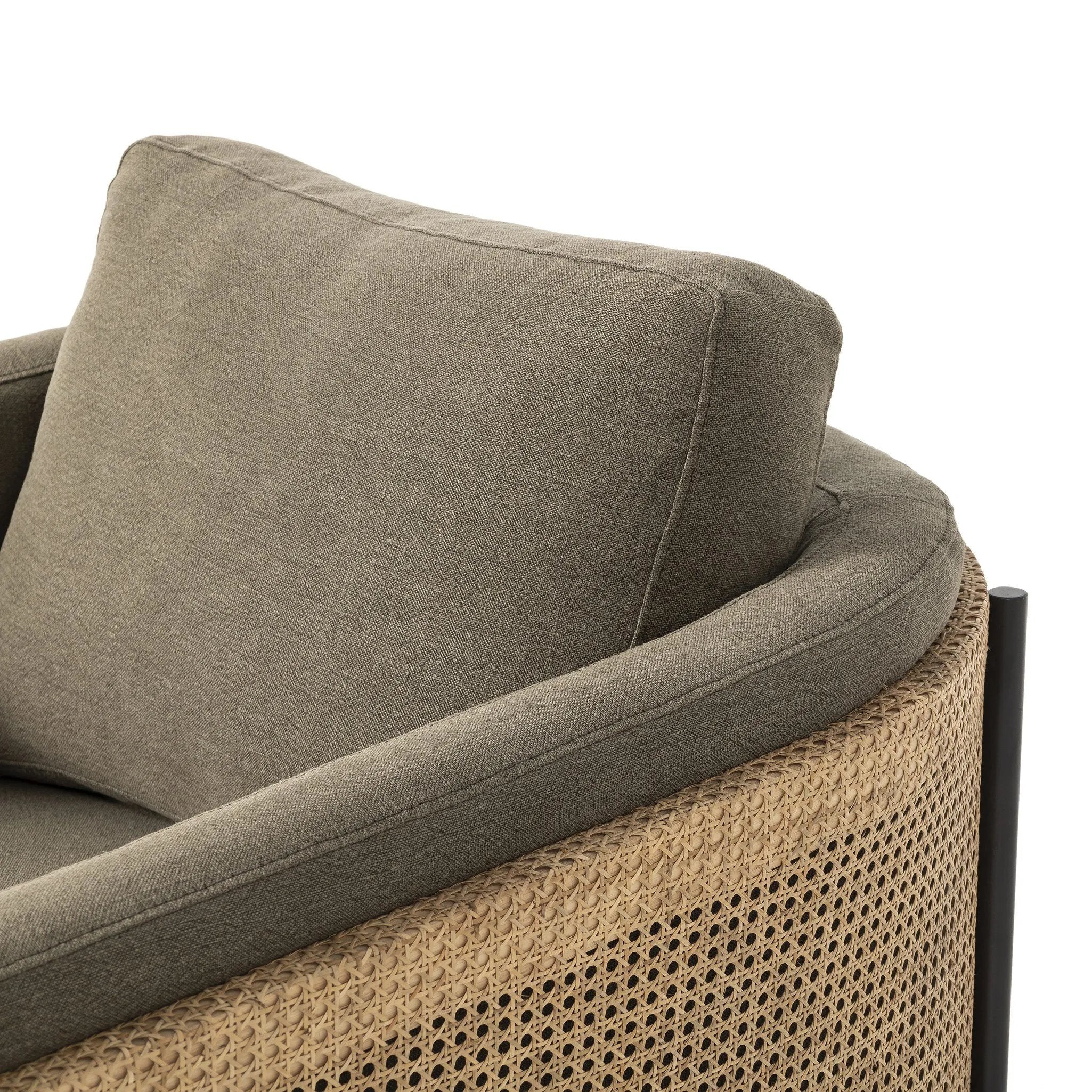 On-trend and expertly tailored, a texture-driven chair is upholstered in an olive flax/linen blend and wrapped with natural rattan, with linear iron legs finished in a complementary gunmetal Amethyst Home provides interior design, new home construction design consulting, vintage area rugs, and lighting in the Nashville metro area.