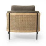 On-trend and expertly tailored, a texture-driven chair is upholstered in an olive flax/linen blend and wrapped with natural rattan, with linear iron legs finished in a complementary gunmetal Amethyst Home provides interior design, new home construction design consulting, vintage area rugs, and lighting in the Seattle metro area.