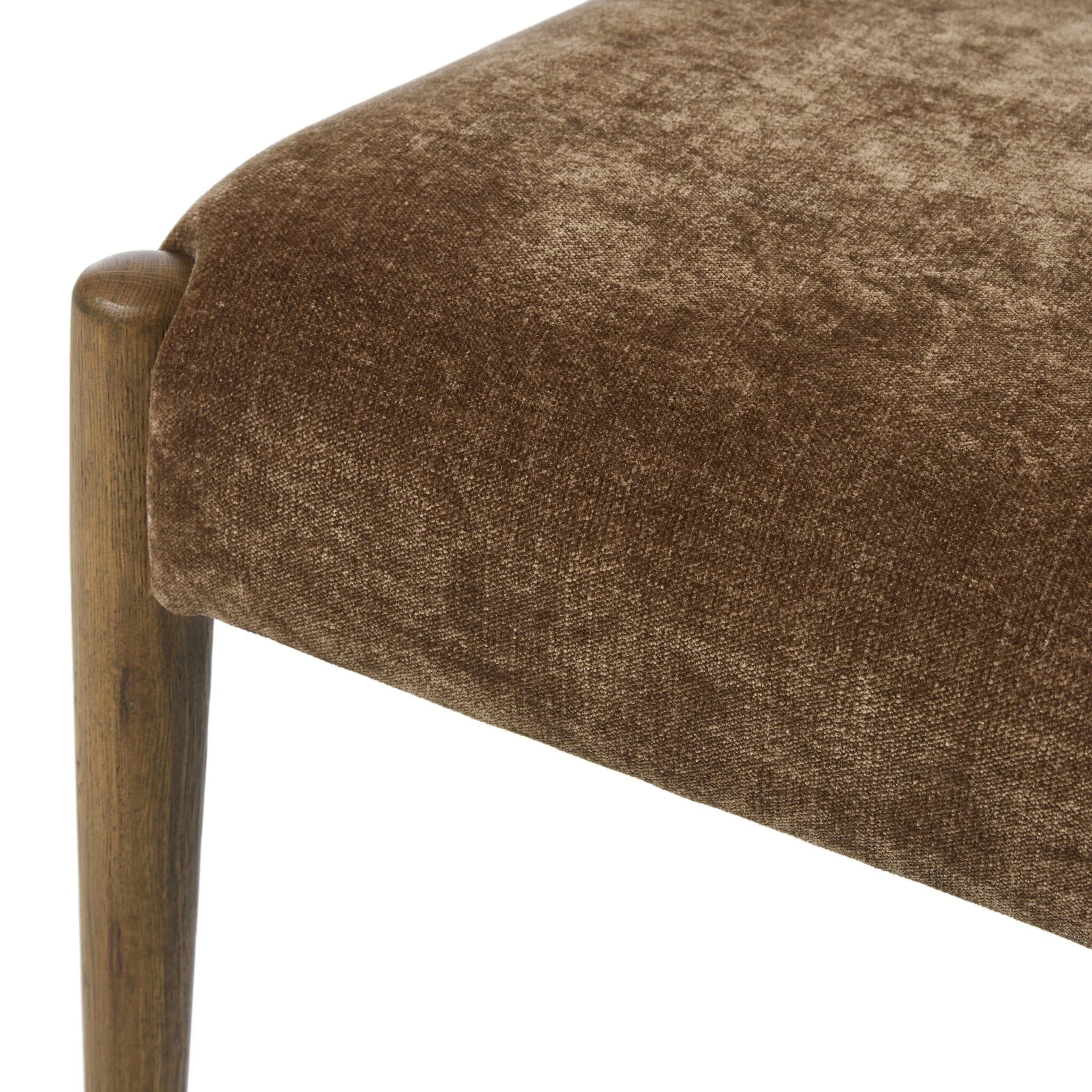 A midcentury-inspired piece brought to modern times. A supportive, sling-style back and seat cushion are upholstered in a soft, velvety fabric, with toasted oak armless framing Amethyst Home provides interior design, new home construction design consulting, vintage area rugs, and lighting in the San Diego metro area.