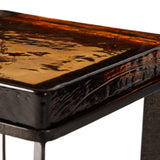 Featuring Lennie Amber Cast Glass Cast Glass End Table by Four Hands at Amethyst Home. An airy, angular base of charcoal-burnished iron supports a squared tabletop of amber cast glass, perfectly sized to keep your drink or book within reach.Overall Dimensions: 12.50"w x 12.50"d x 22.00"hWeight : 36.38 lbsMaterials : Cast Glass, Iron. Amethyst Home provides interior design, new home construction design consulting, vintage area rugs, and lighting in the Austin metro area.