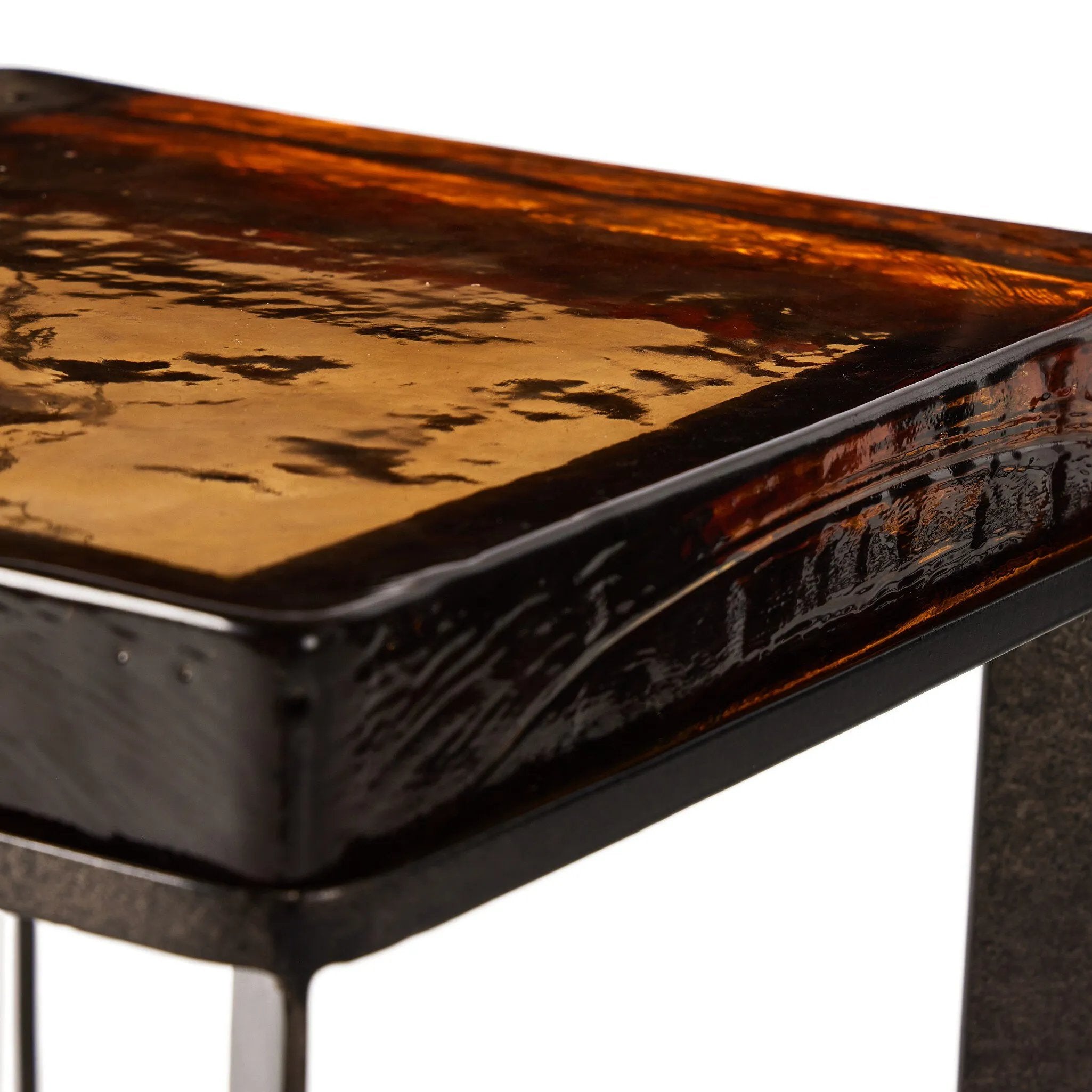 Featuring Lennie Amber Cast Glass Cast Glass End Table by Four Hands at Amethyst Home. An airy, angular base of charcoal-burnished iron supports a squared tabletop of amber cast glass, perfectly sized to keep your drink or book within reach.Overall Dimensions: 12.50"w x 12.50"d x 22.00"hWeight : 36.38 lbsMaterials : Cast Glass, Iron. Amethyst Home provides interior design, new home construction design consulting, vintage area rugs, and lighting in the Austin metro area.