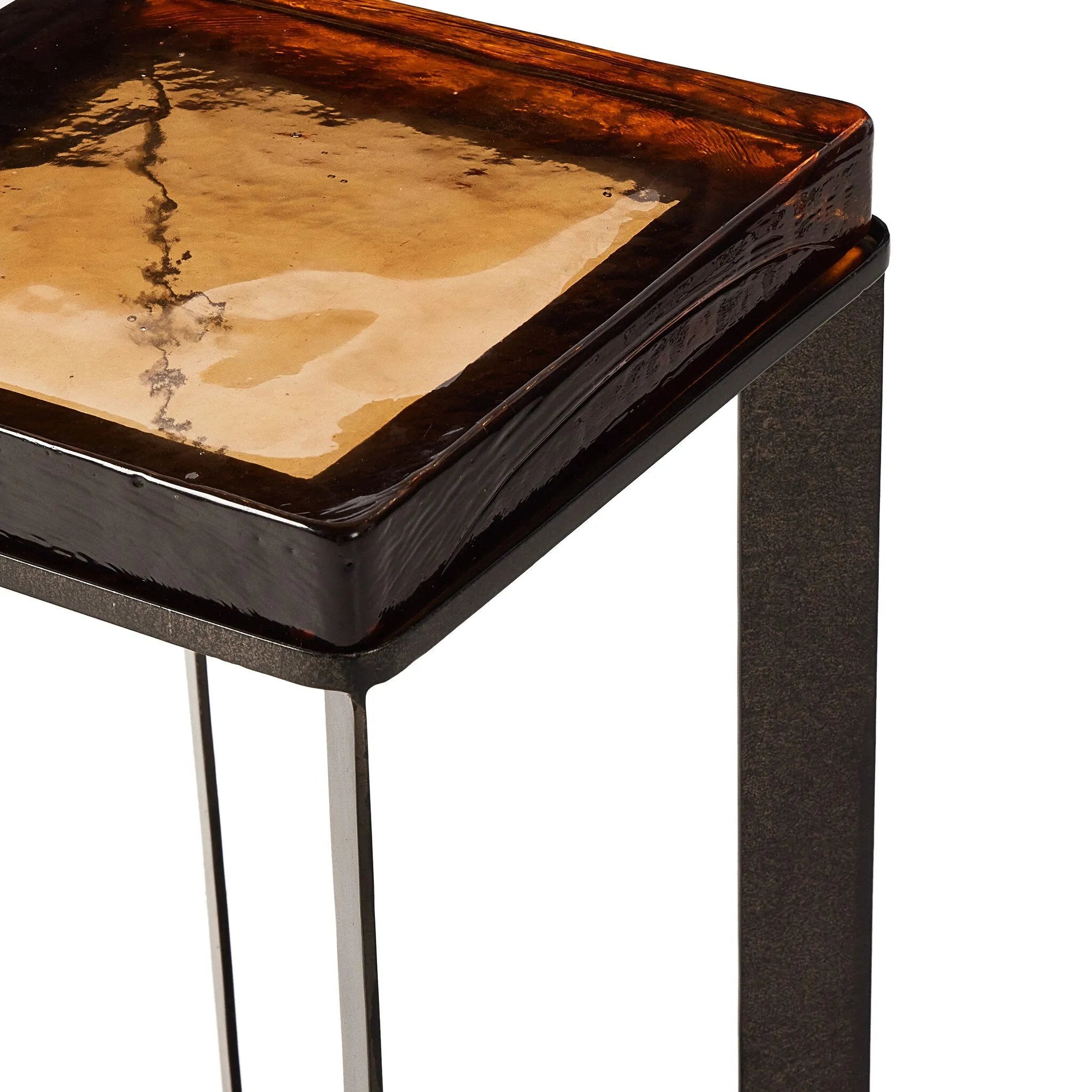Featuring Lennie Amber Cast Glass Cast Glass End Table by Four Hands at Amethyst Home. An airy, angular base of charcoal-burnished iron supports a squared tabletop of amber cast glass, perfectly sized to keep your drink or book within reach.Overall Dimensions: 12.50"w x 12.50"d x 22.00"hWeight : 36.38 lbsMaterials : Cast Glass, Iron. Amethyst Home provides interior design, new home construction design consulting, vintage area rugs, and lighting in the Scottsdale metro area.
