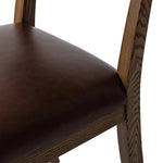 Both modern and traditional, toasted oak frames this high-back, armless dining chair. Finished with a rich brown top-grain leather, with hanging straps affixed to the back Amethyst Home provides interior design, new home construction design consulting, vintage area rugs, and lighting in the Nashville metro area.