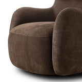 Modern wingback with a twist of barrel back design, this enveloping swivel chair comes with velvety upholstery in a deep brow