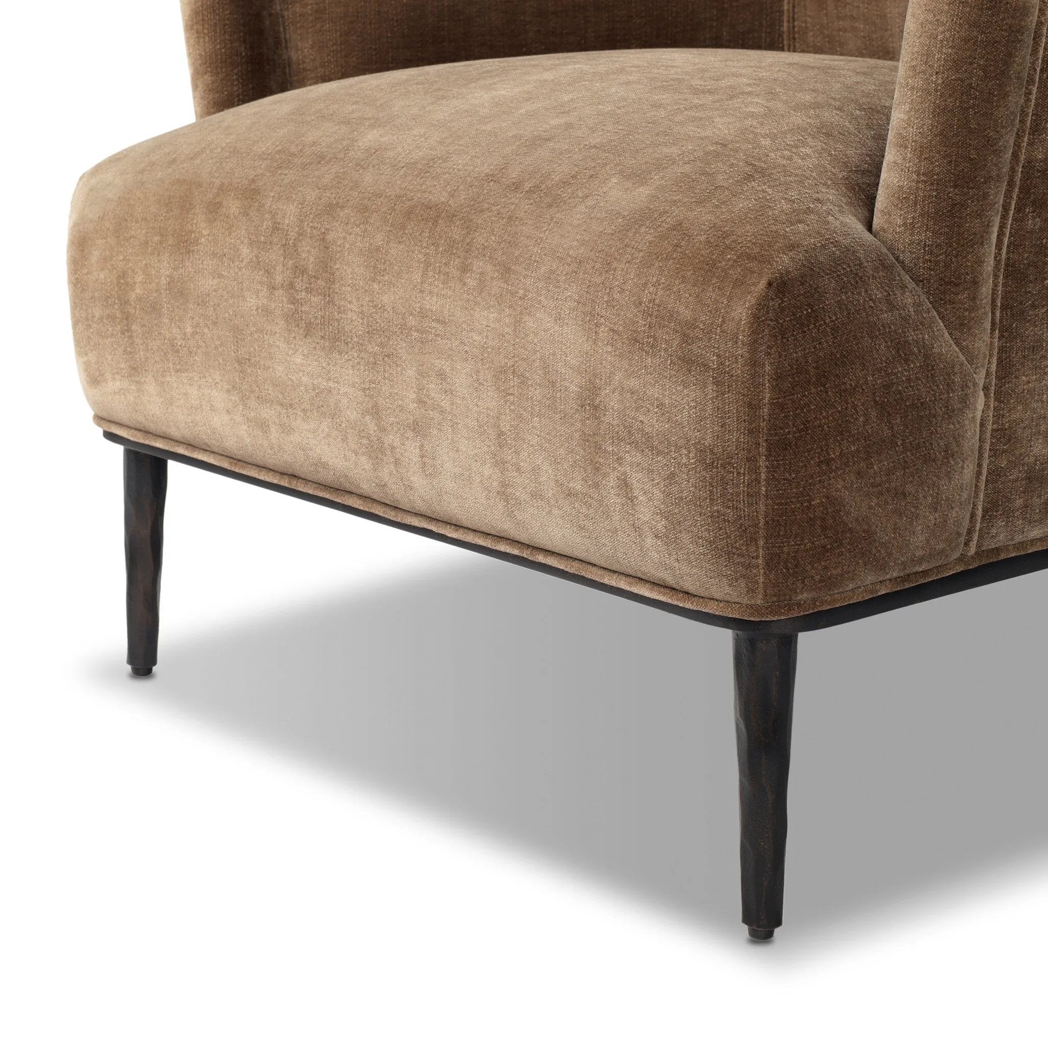 With elements of past eras at play, this updated Deco chair features a rounded back, sloped arms and a dramatic channel. The