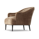 With elements of past eras at play, this updated Deco chair features a rounded back, sloped arms and a dramatic channel. The
