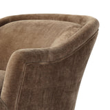 With elements of past eras at play, this updated Deco chair features a rounded back, sloped arms and a dramatic channel. The