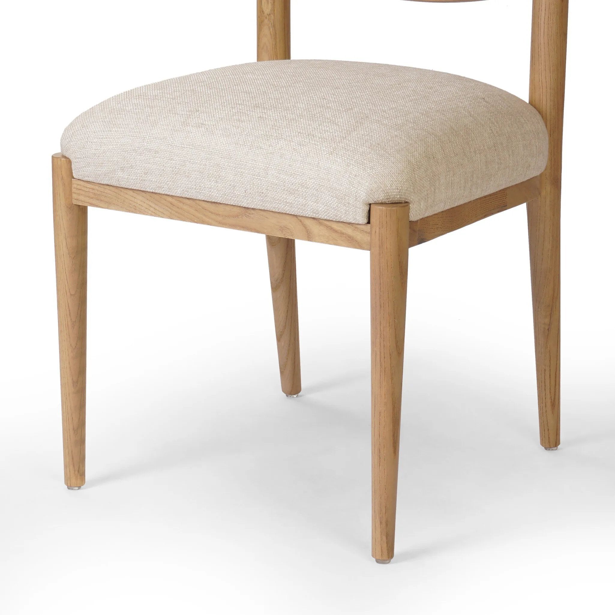 Featuring Piran Essence Natural Dining Chair by Four Hands at Amethyst Home. A celebration of simplicity. Natural nettlewood frames a comfortable linen-blend seat, while a subtle arc at the backrest's base softens clean, tapered lines. Performance fabrics are specially created to withstand spills, stains, high traffic and wear, ensuring long-term comfort an. Amethyst Home provides interior design, new home construction design consulting, vintage area rugs, and lighting in the Nashville metro area.