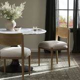 Featuring Piran Essence Natural Dining Chair by Four Hands at Amethyst Home. A celebration of simplicity. Natural nettlewood frames a comfortable linen-blend seat, while a subtle arc at the backrest's base softens clean, tapered lines. Performance fabrics are specially created to withstand spills, stains, high traffic and wear, ensuring long-term comfort and un. Amethyst Home provides interior design, new home construction design consulting, vintage area rugs, and lighting in the Omaha metro area.