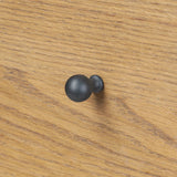 Create storage space in the bedroom with a five-drawer dresser of amber-finished oak. Chunky dowel legs support a tall silhouette and overhang top, all finished out with simple gunmetal hardware Amethyst Home provides interior design, new home construction design consulting, vintage area rugs, and lighting in the Calabasas metro area.