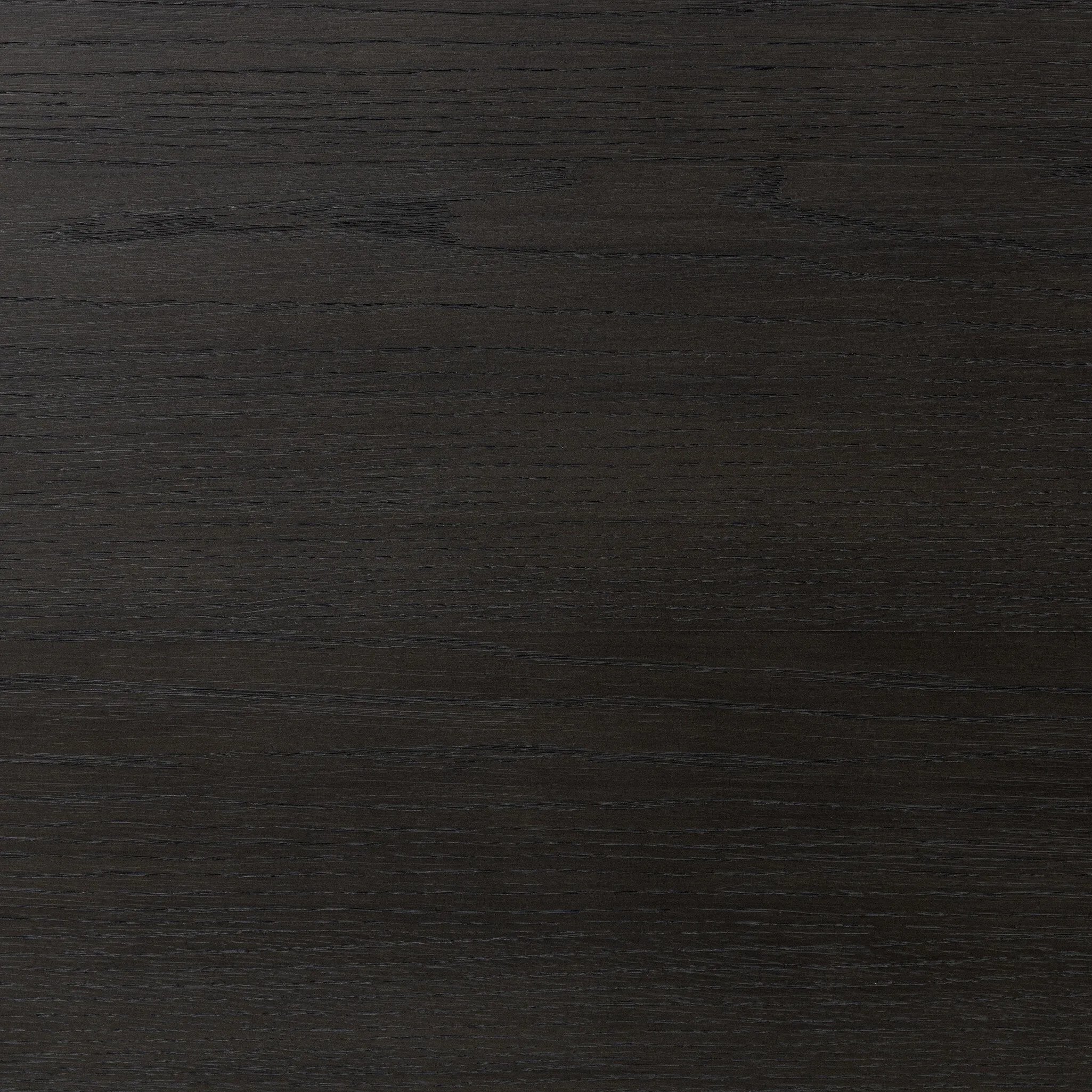 Create storage space in the bedroom with a five-drawer dresser of ebony-finished oak. Chunky dowel legs support a tall silhouette and overhang top, all finished out with simple gunmetal hardware Amethyst Home provides interior design, new home construction design consulting, vintage area rugs, and lighting in the Alpharetta metro area.