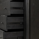 Create storage space in the bedroom with a five-drawer dresser of ebony-finished oak. Chunky dowel legs support a tall silhouette and overhang top, all finished out with simple gunmetal hardware Amethyst Home provides interior design, new home construction design consulting, vintage area rugs, and lighting in the Calabasas metro area.