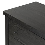 Create storage space in the bedroom with a five-drawer dresser of ebony-finished oak. Chunky dowel legs support a tall silhouette and overhang top, all finished out with simple gunmetal hardware Amethyst Home provides interior design, new home construction design consulting, vintage area rugs, and lighting in the Park City metro area.